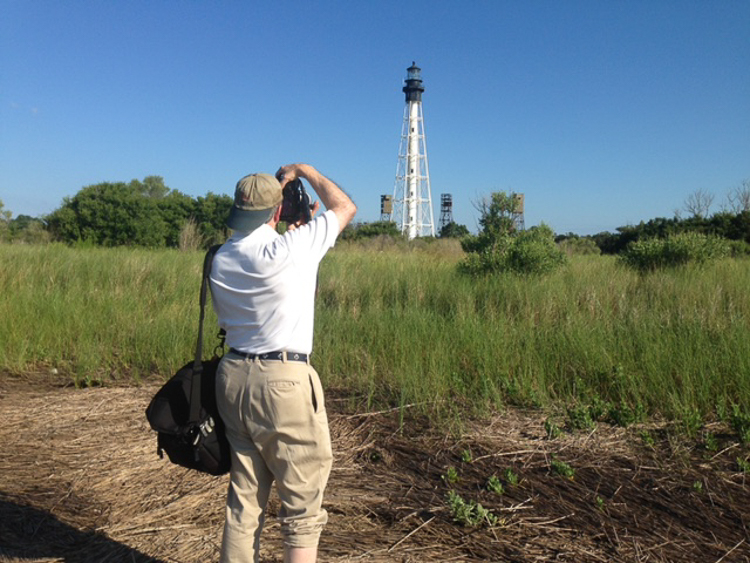 Bryan Hatchett. copyright, photograph of Bryan Hatchett, photographer and author and photographer of a book, Tidewater Spirit, photographing Cape Charles Lighthouse, Smith Island, Virginia