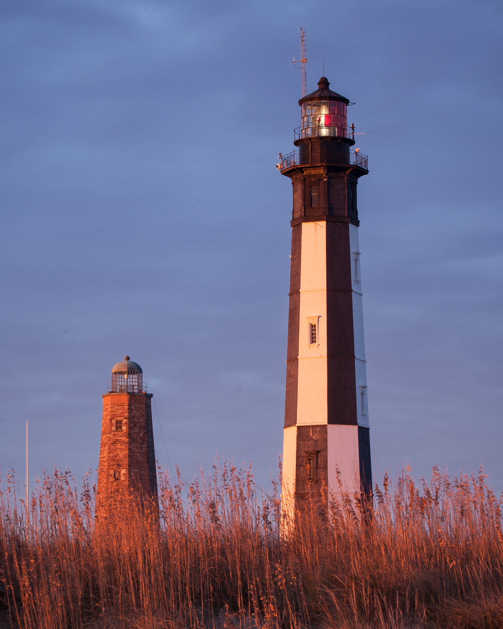 photograph by Bryan Hatchett, copyright, Bryan Hatchett, color photograph, the two two Cape Henry lighthouses; on the left, completed in October, 1792, on the right, constructed in 1881. Ft. Story, Virginia Beach, Virginia